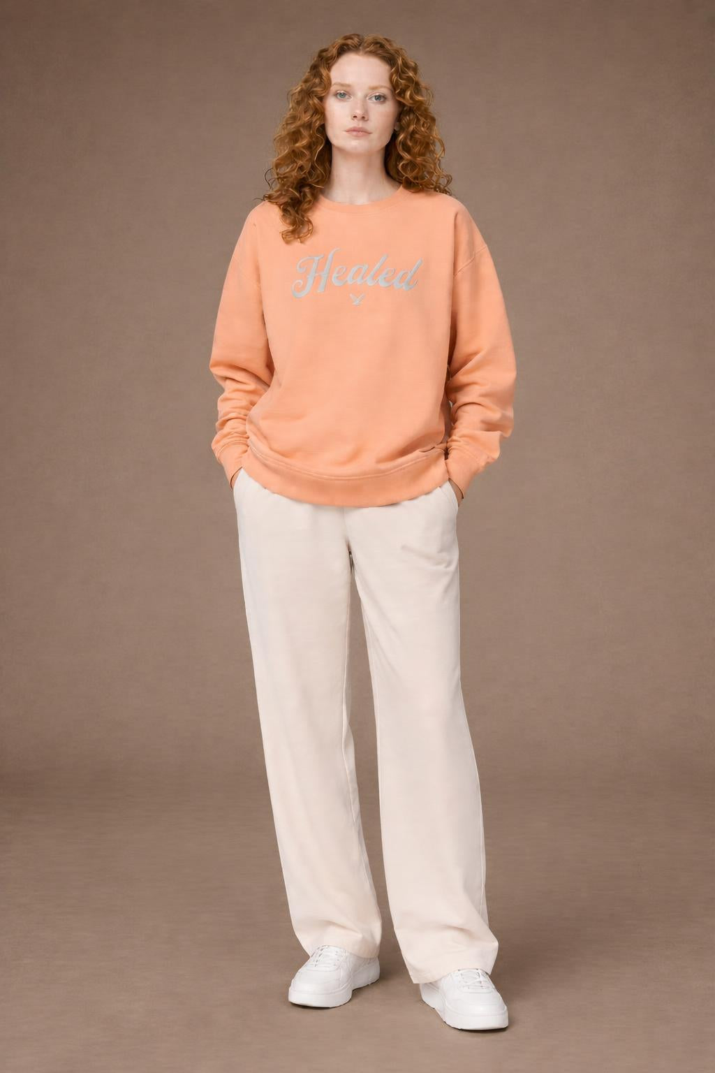 Full body view of the model wearing Healed fleece crewneck sweatshirt