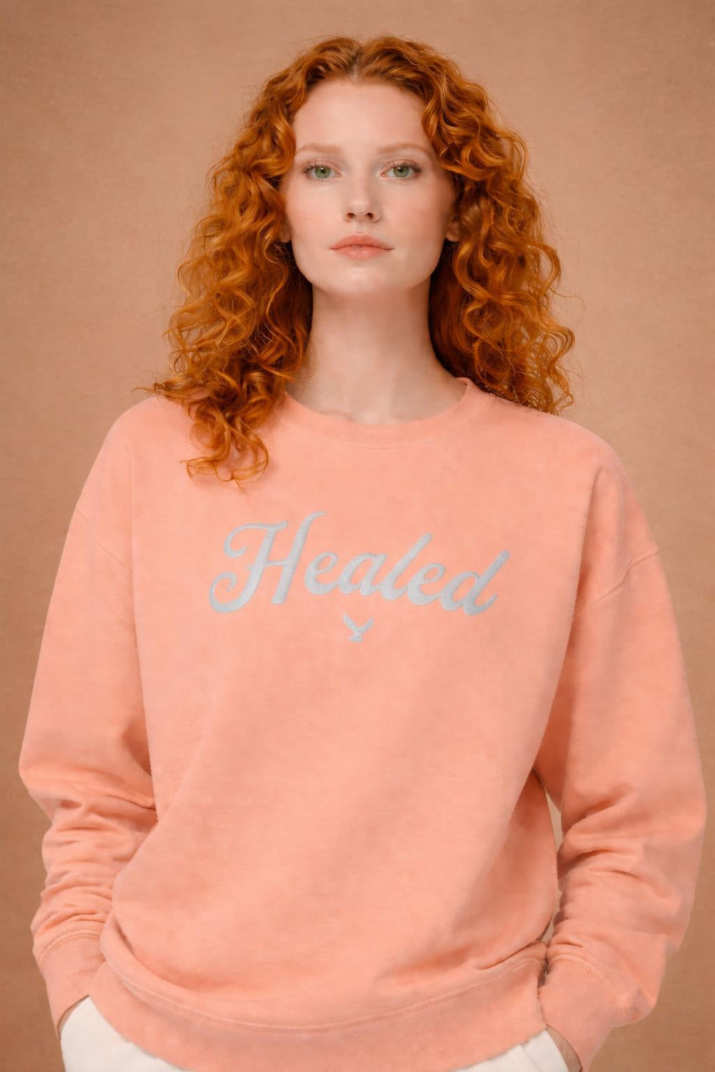 Close-up of the model wearing Healed fleece crewneck sweatshirt