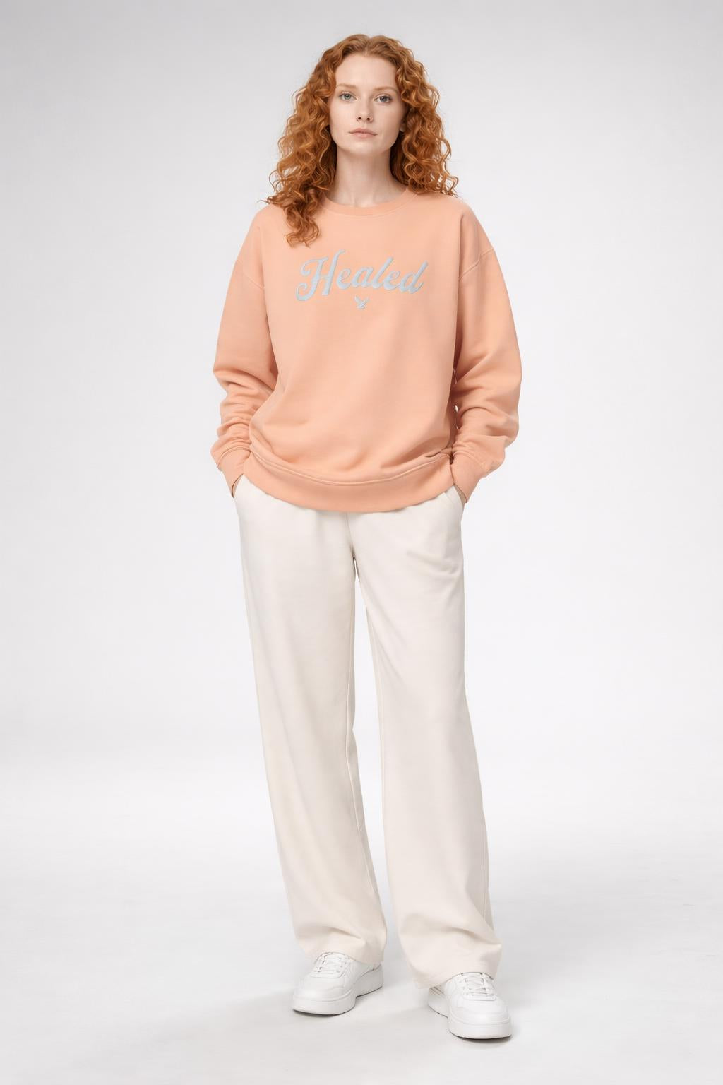 Full body view of the model wearing Healed fleece crewneck sweatshirt