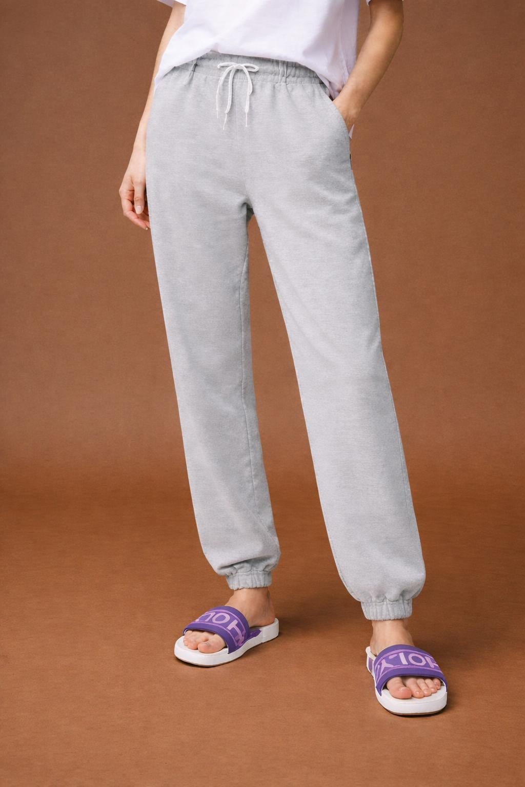 Close-up of the model's lower body wearing HOLY slides